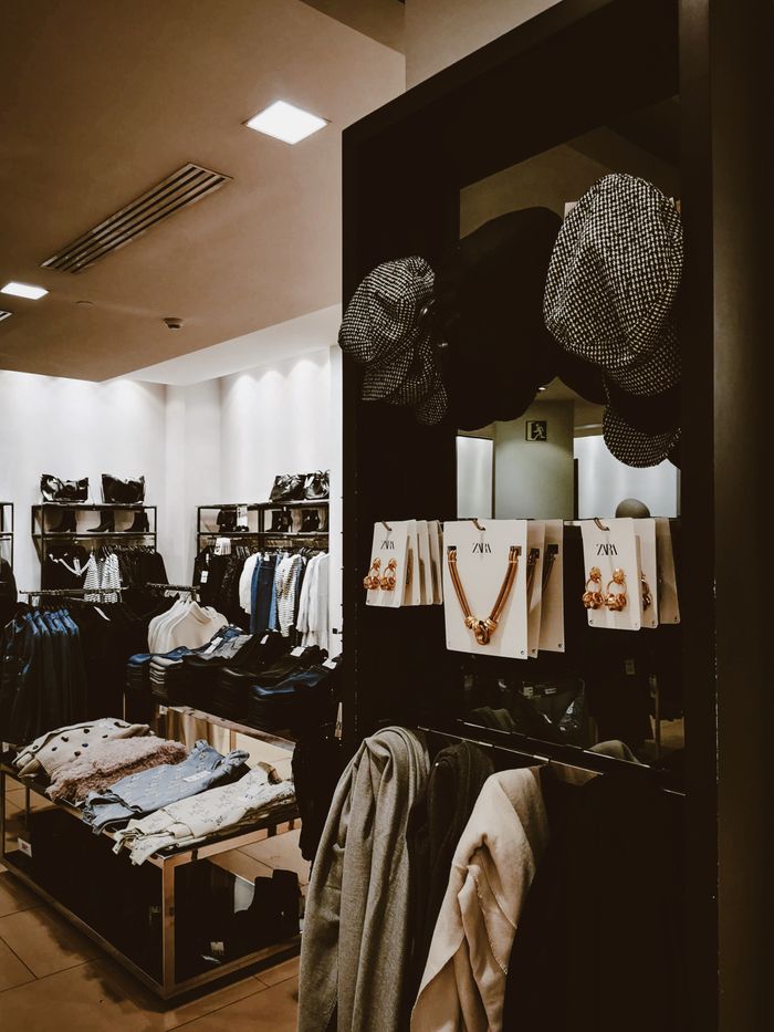 Stylish retail store showcasing hats and fashionable clothing displays.